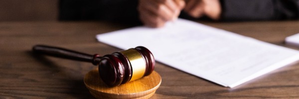 A desk with papers and a gavel