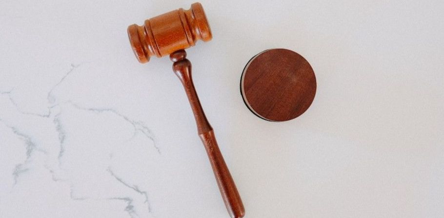 A gavel on a white marbled surface
