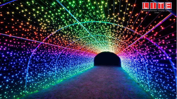 Tunnel in the dark lit up with colourful string lights